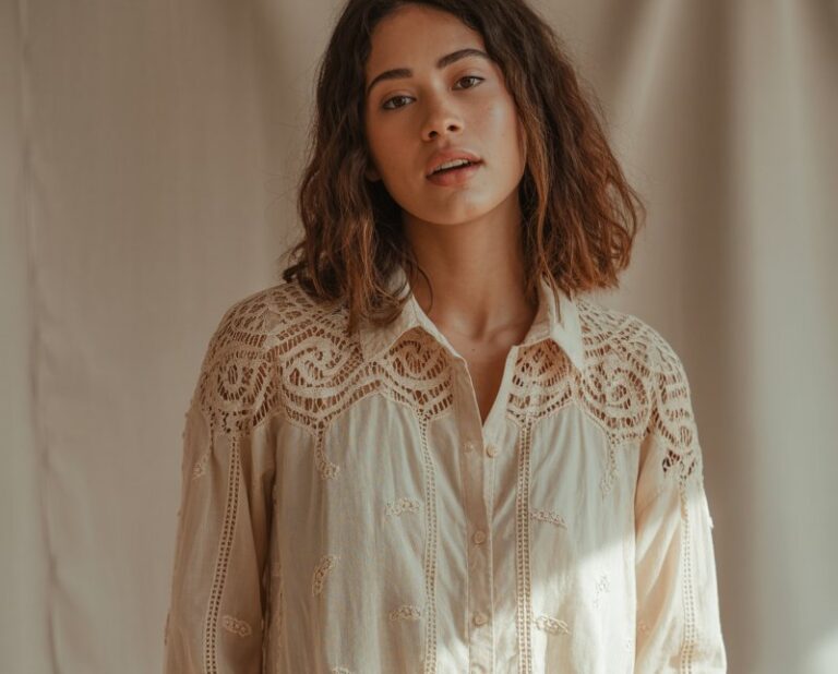 A natural-looking young woman wearing a lace blouse paired with relaxed cargo pants for a modern edge. Theme Lace Tops and Outfits