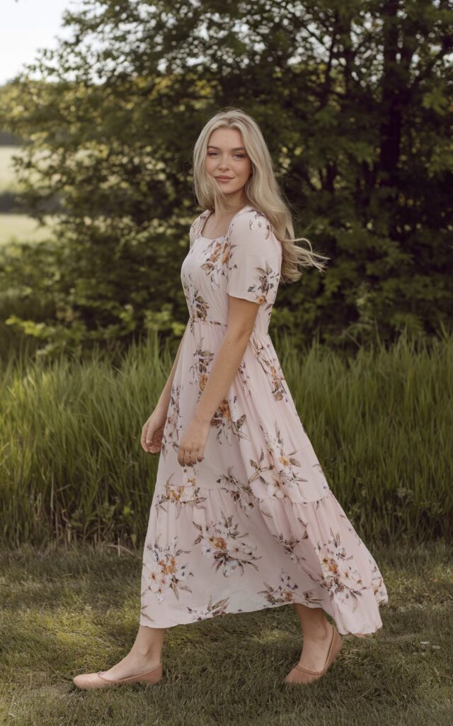 A natural-looking young woman wearing a lightweight maxi dress paired with comfortable flats. Theme girly summer outfits