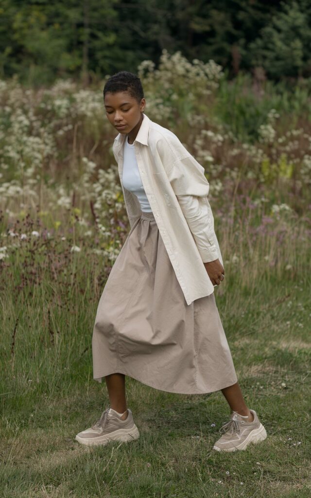 A natural-looking young woman wearing a minimal outfit grounded with chunky sneakers. Theme tomboy outfits
