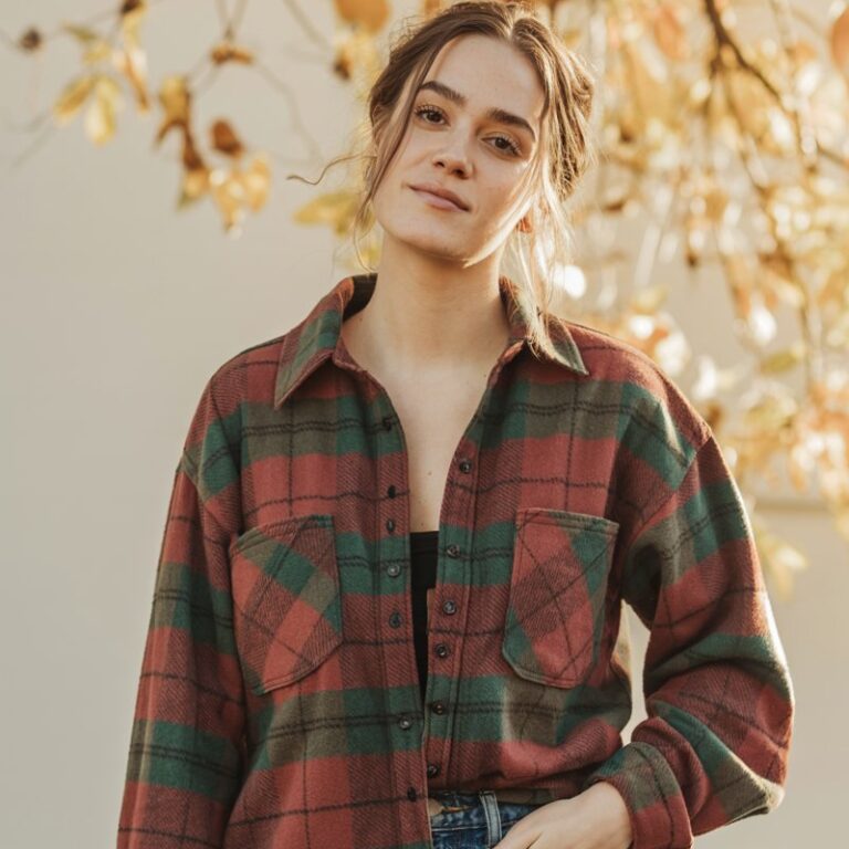 A natural-looking young woman wearing an oversized flannel paired with high-waisted straight-leg jeans. Theme casual fall outfits