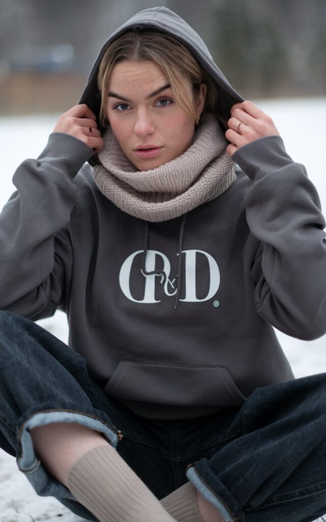 A natural-looking young woman wearing dark-wash baggy jeans styled for a refined winter look. Theme baggy jeans outfit winter