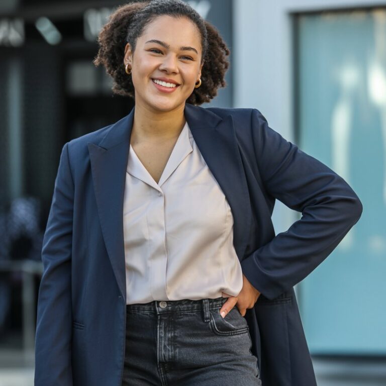 "A natural-looking young curvy woman wearing a structured blazer over skinny or straight-leg jeans. Theme: curvy outfits."