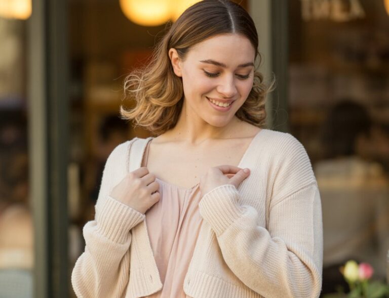 A natural-looking young woman wearing a flowy mini dress layered with a cropped cardigan. Theme valentines day outfits