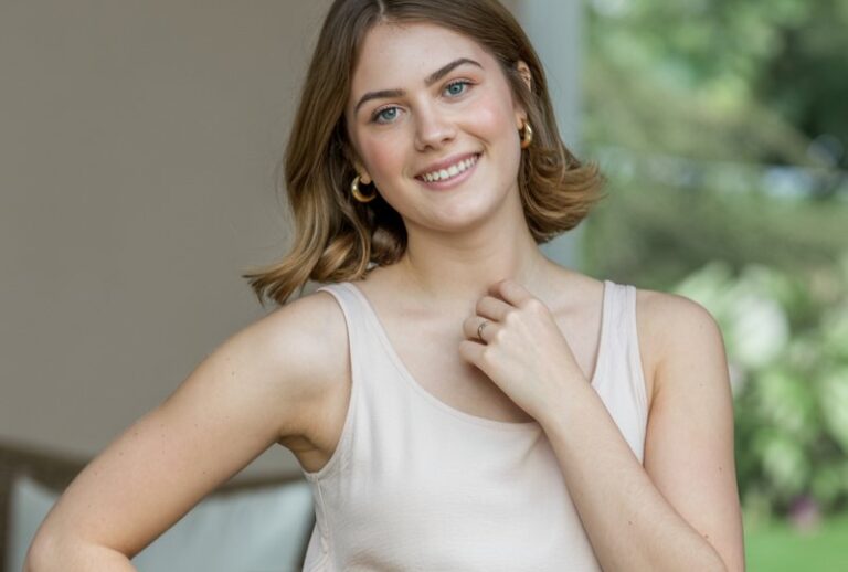 A natural-looking young woman wearing a simple dress elevated with a bold statement belt. Theme family photo outfits